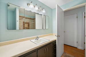 Bathroom featuring vanity and tiled shower