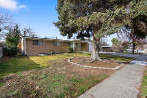 Ranch-style home with brick siding, a garage, and driveway