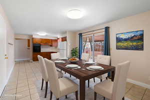 Dining room with baseboards and light tile patterned floors