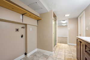 Laundry room with hookup for a washing machine and a textured ceiling