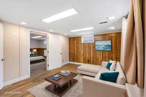 Living area featuring wooden walls and wood finished floors