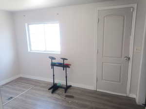 Unfurnished room with dark wood-style flooring