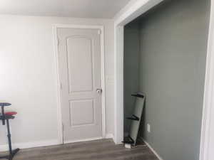 Hall with a textured ceiling and dark wood-style floors