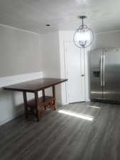 Unfurnished dining area with dark wood finished floors