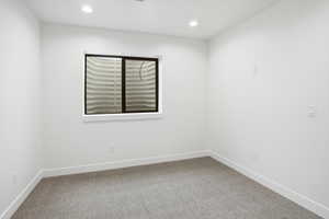 Spare room featuring light carpet and recessed lighting