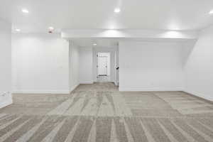 Spare room featuring light carpet and recessed lighting