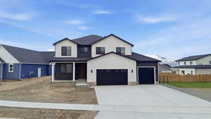 View of front of home with stucco siding, driveway, a shingled roof, and covered porch