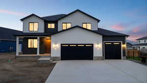 View of front of property with a porch, stucco siding, driveway, and a garage