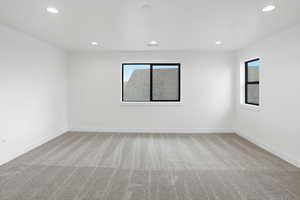 Empty room featuring light carpet and recessed lighting