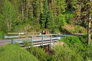 View of pool with a playground and a water view