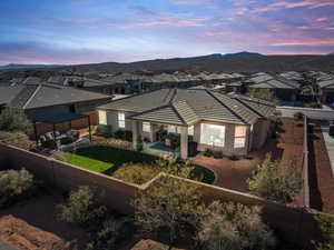 Rear view of house with a residential view, a patio area, stucco siding, a fenced backyard, and an outdoor living space