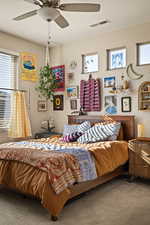 Bedroom featuring multiple windows, carpet, and ceiling fan