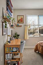Home office featuring light carpet and baseboards