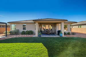 Back of house with stucco siding, a patio area, and a tiled roof