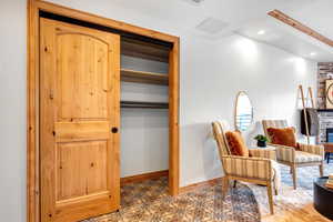 Living area with a brick fireplace, tile patterned floors, and recessed lighting