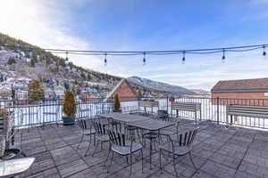 View of patio with outdoor dining area and a mountain view