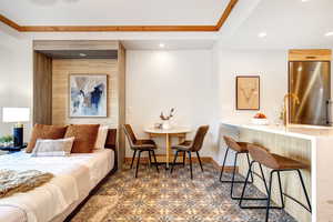 Bedroom featuring high end fridge, crown molding, and recessed lighting