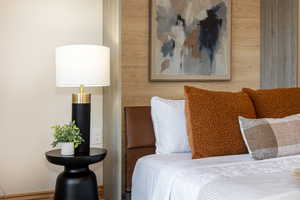 Bedroom featuring wooden walls
