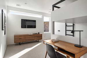 Carpeted office with plenty of natural light