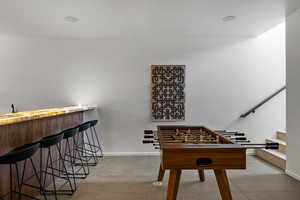 Rec room with wet bar and baseboards