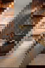 Corridor featuring light tile patterned flooring and baseboards