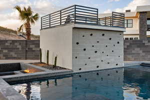 View of swimming pool with a fire pit