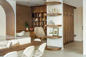 Dining area with arched walkways and built in shelves