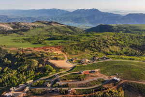 Aerial view of property and surrounding area with a mountainous background
