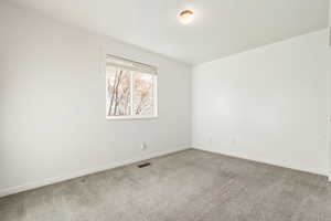 Carpeted empty room with baseboards