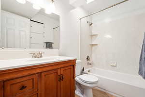 Full bathroom with shower / bath combination, vanity, and light tile patterned floors
