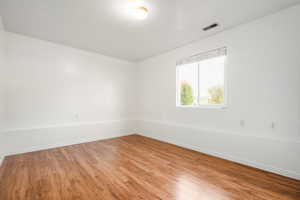 Empty room with wood finished floors and baseboards