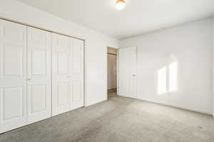 Unfurnished bedroom with carpet floors and a closet