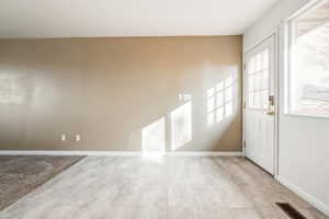 Foyer entrance with baseboards