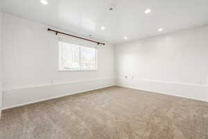 Unfurnished room with recessed lighting and carpet flooring