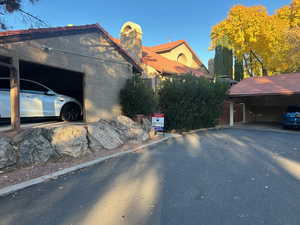 View of home's exterior with a chimney and stucco siding