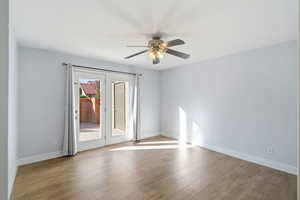 Spare room featuring light wood-style floors and ceiling fan