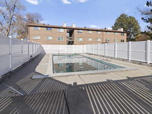 View of pool with a patio area and a fenced backyard