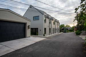 View of side of property with garage and common drive