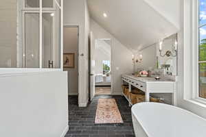 Ensuite bathroom with vanity, a freestanding tub, and walk-in shower
