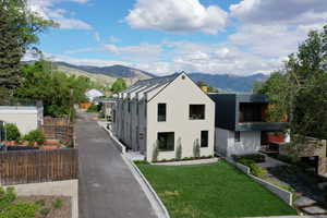 View of front of property with a mountain view and stucco siding