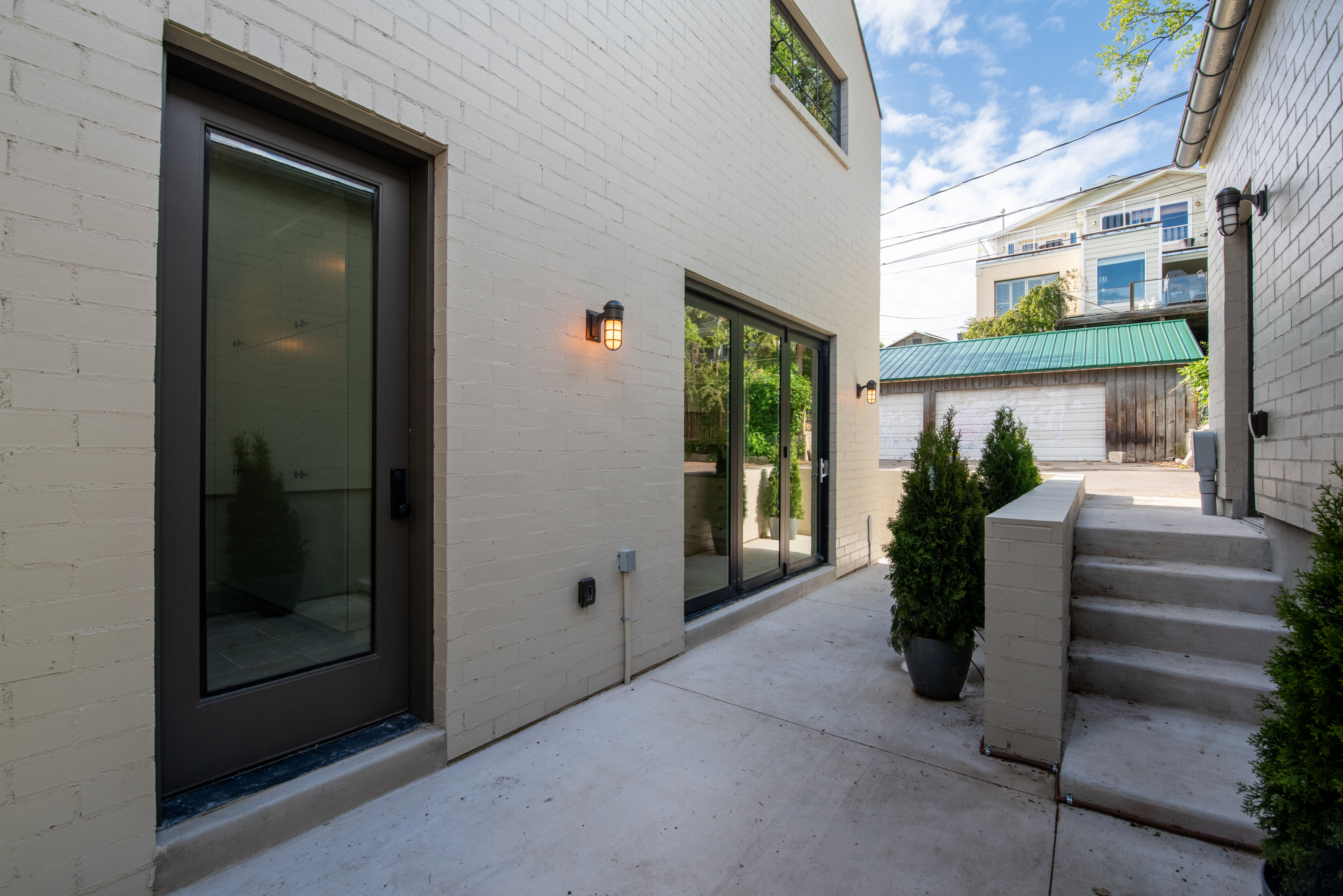Back of home (east), Patio, entry to Mudroom and Kitchen sliding door.