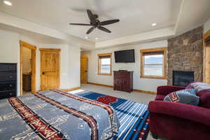 Carpeted bedroom featuring recessed lighting, a ceiling fan, and a fireplace