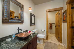 Full bath featuring vanity and light tile patterned floors