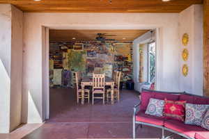 View of patio featuring outdoor dining space, a ceiling fan, and an outdoor hangout area