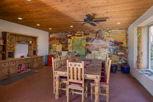Dining area with wooden ceiling, finished concrete floors, ceiling fan, and recessed lighting