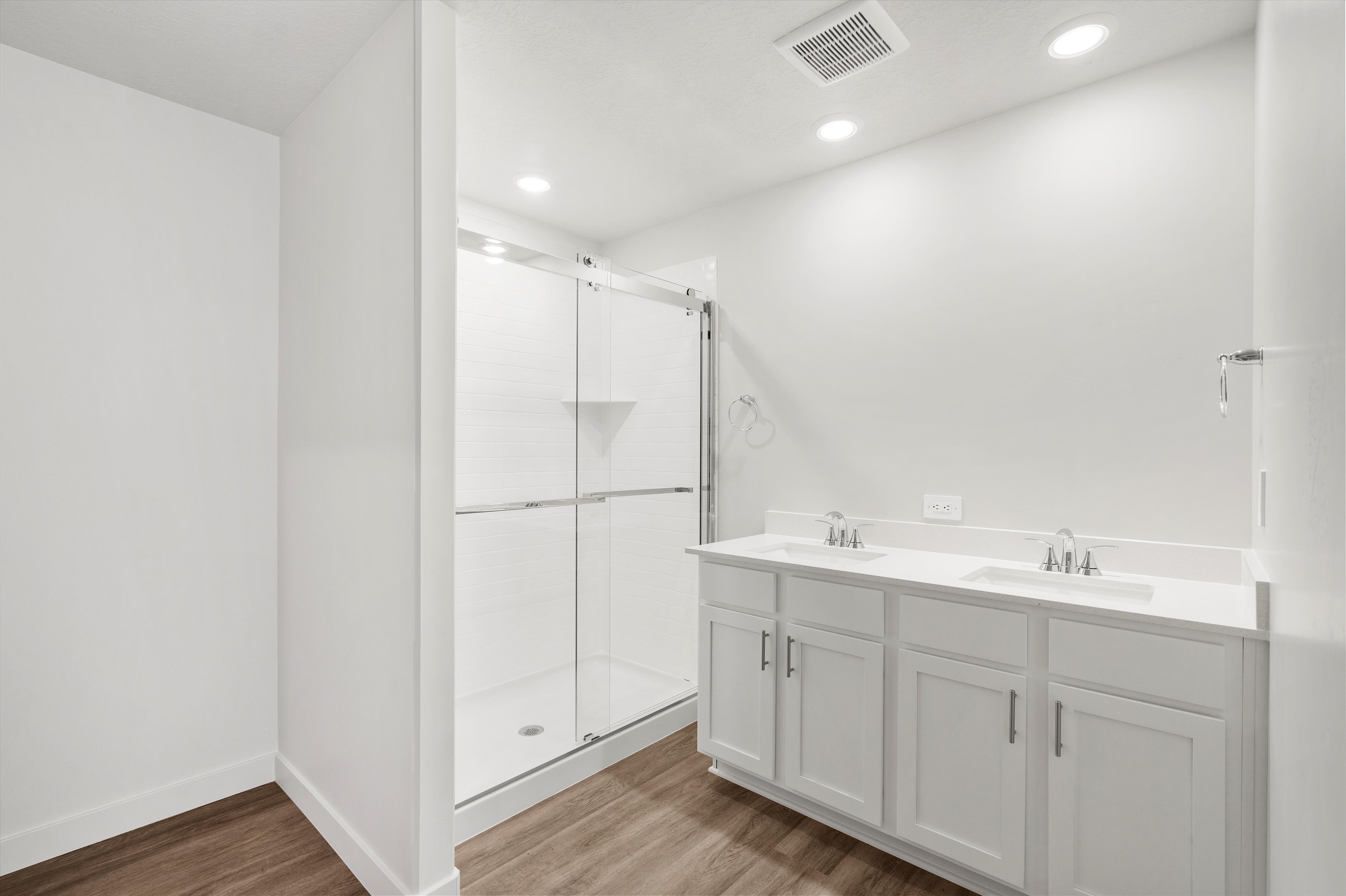**DISLCAIMER** Exterior & Interior packages may vary.Full bath featuring light wood finished floors, double vanity, recessed lighting, and a stall shower
