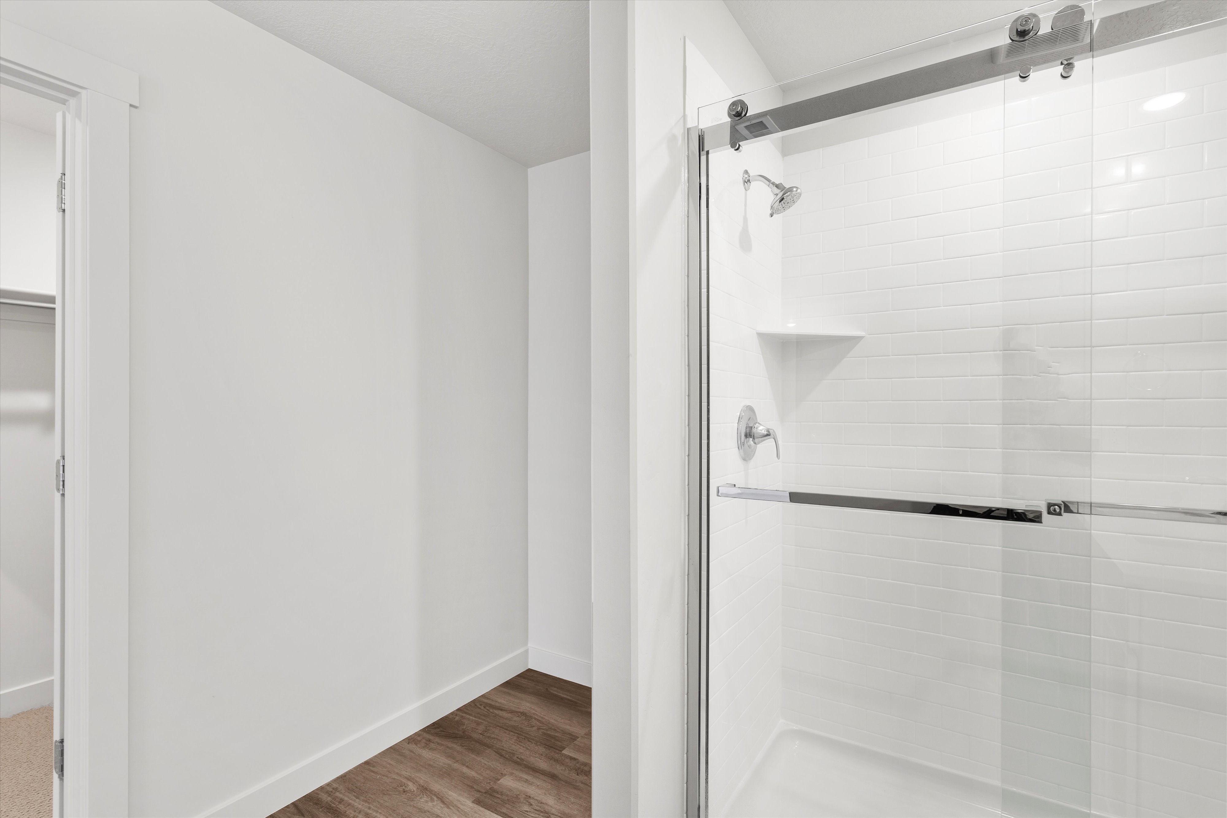 **DISLCAIMER** Exterior & Interior packages may vary.Full bath featuring a stall shower, a spacious closet, and light wood-type flooring
