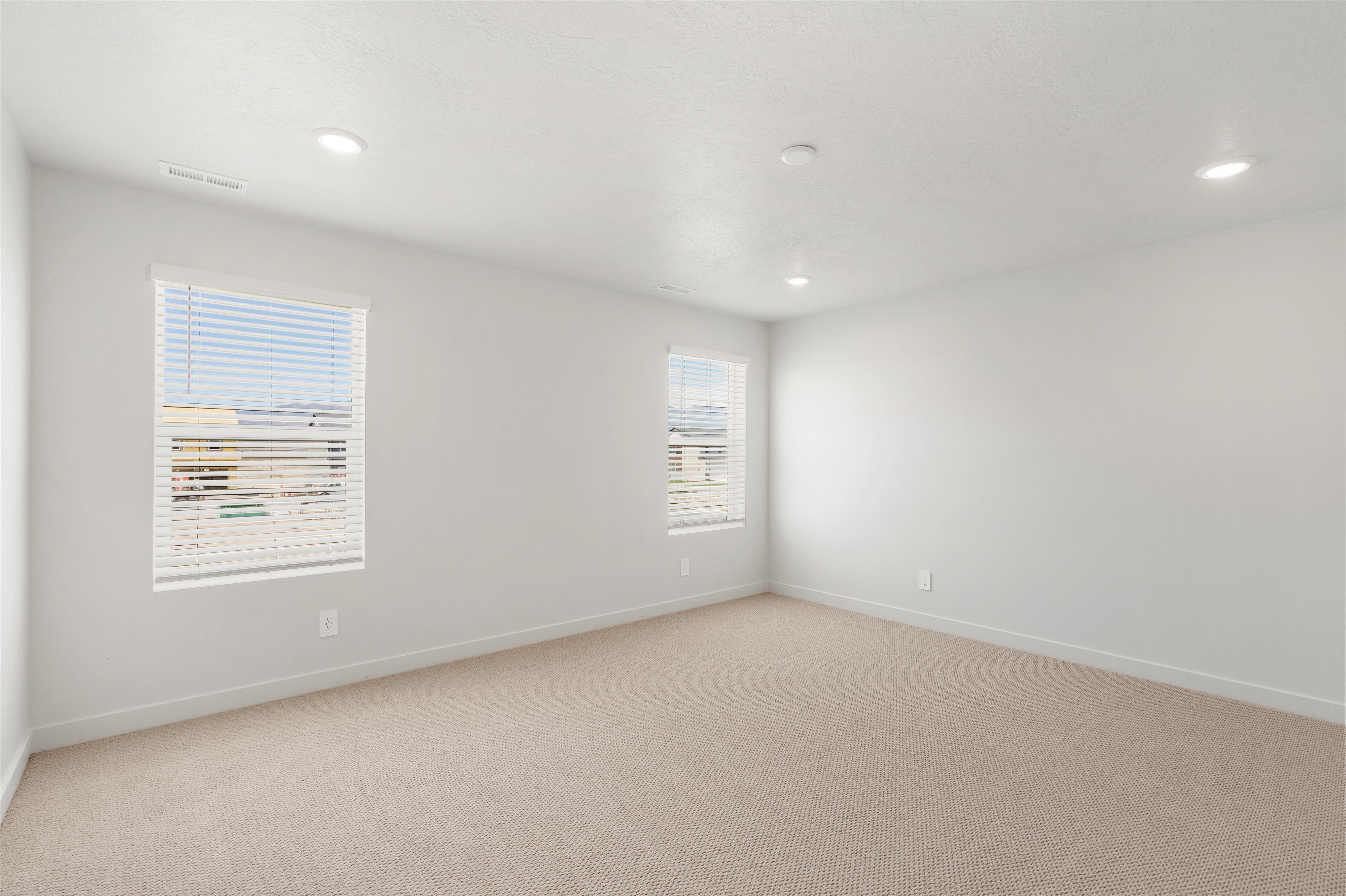 **DISLCAIMER** Exterior & Interior packages may vary.Empty room featuring light colored carpet and recessed lighting
