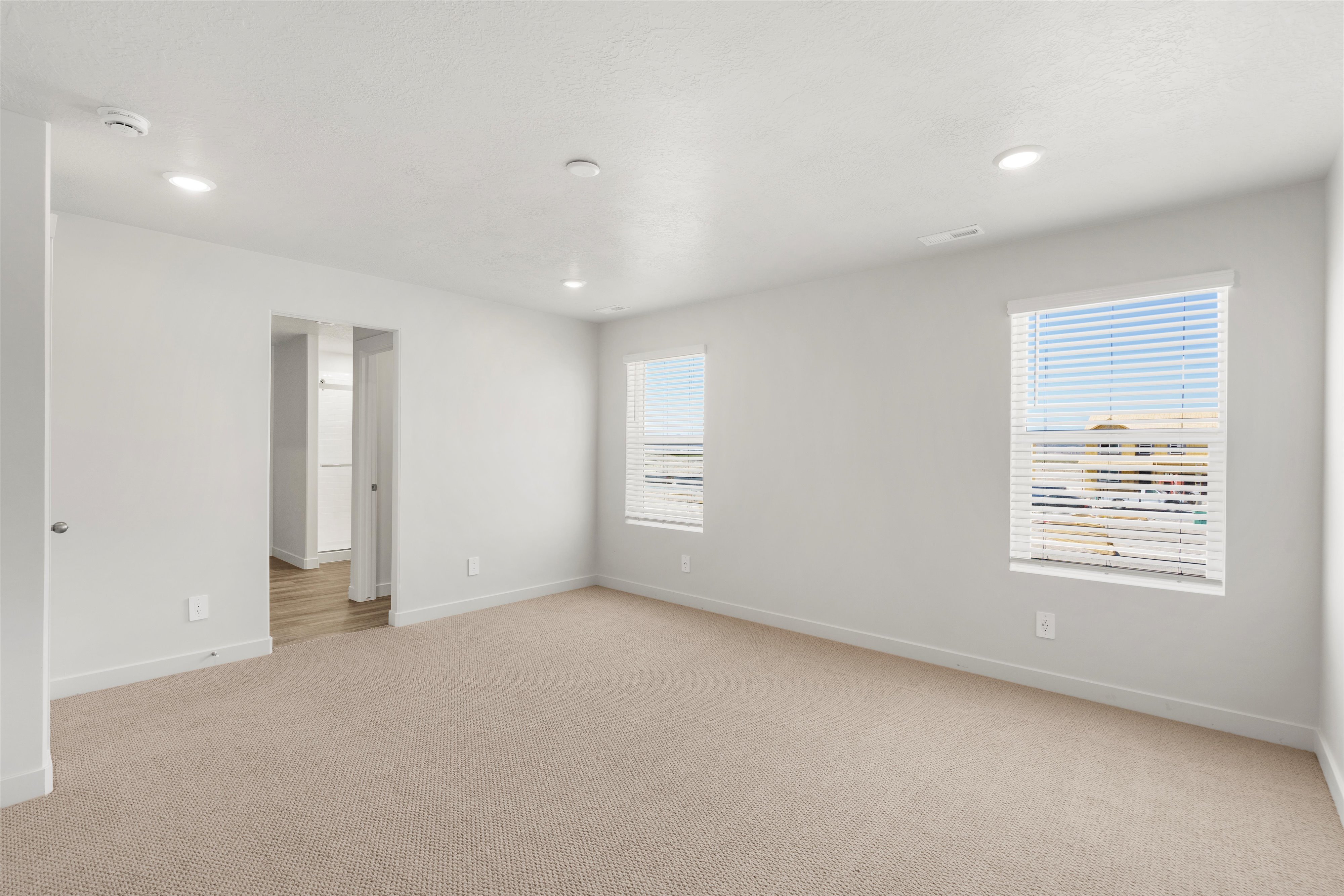 **DISLCAIMER** Exterior & Interior packages may vary.Unfurnished room featuring light carpet and recessed lighting