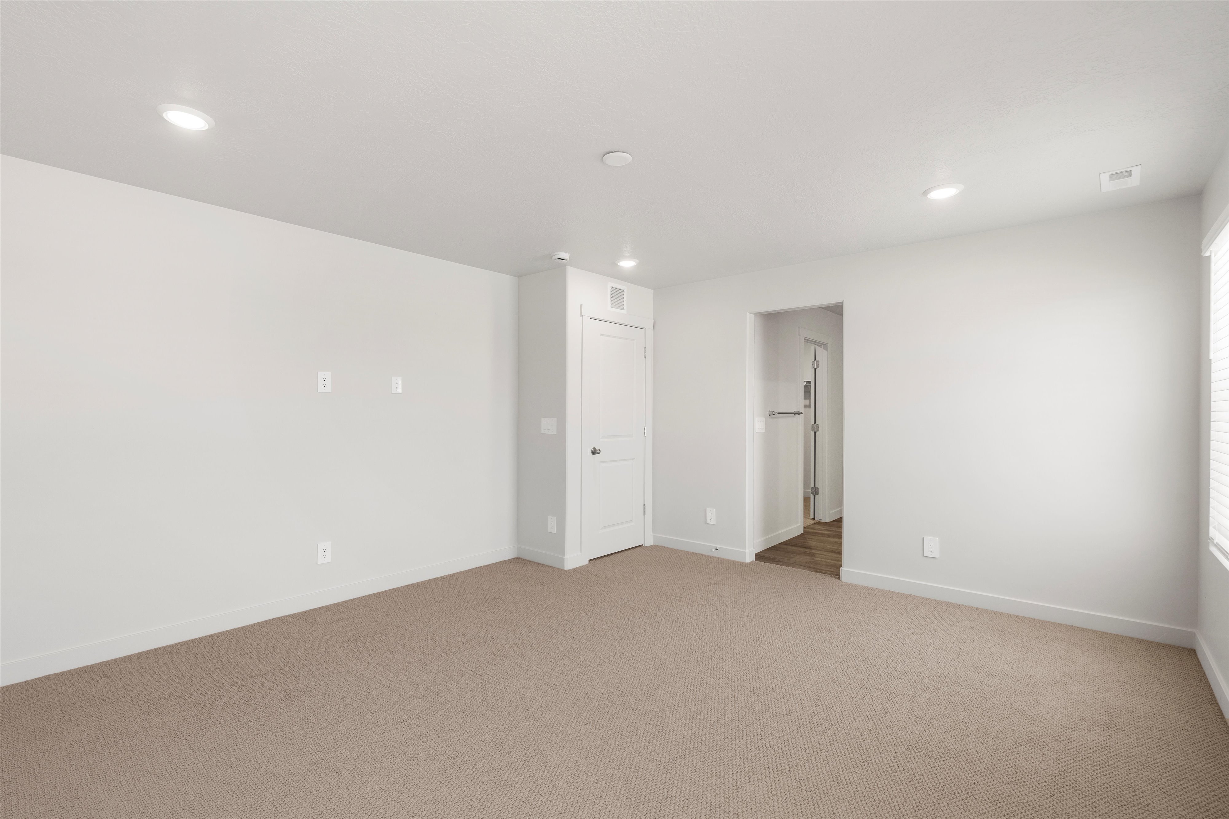 **DISLCAIMER** Exterior & Interior packages may vary.Unfurnished room featuring light carpet and recessed lighting